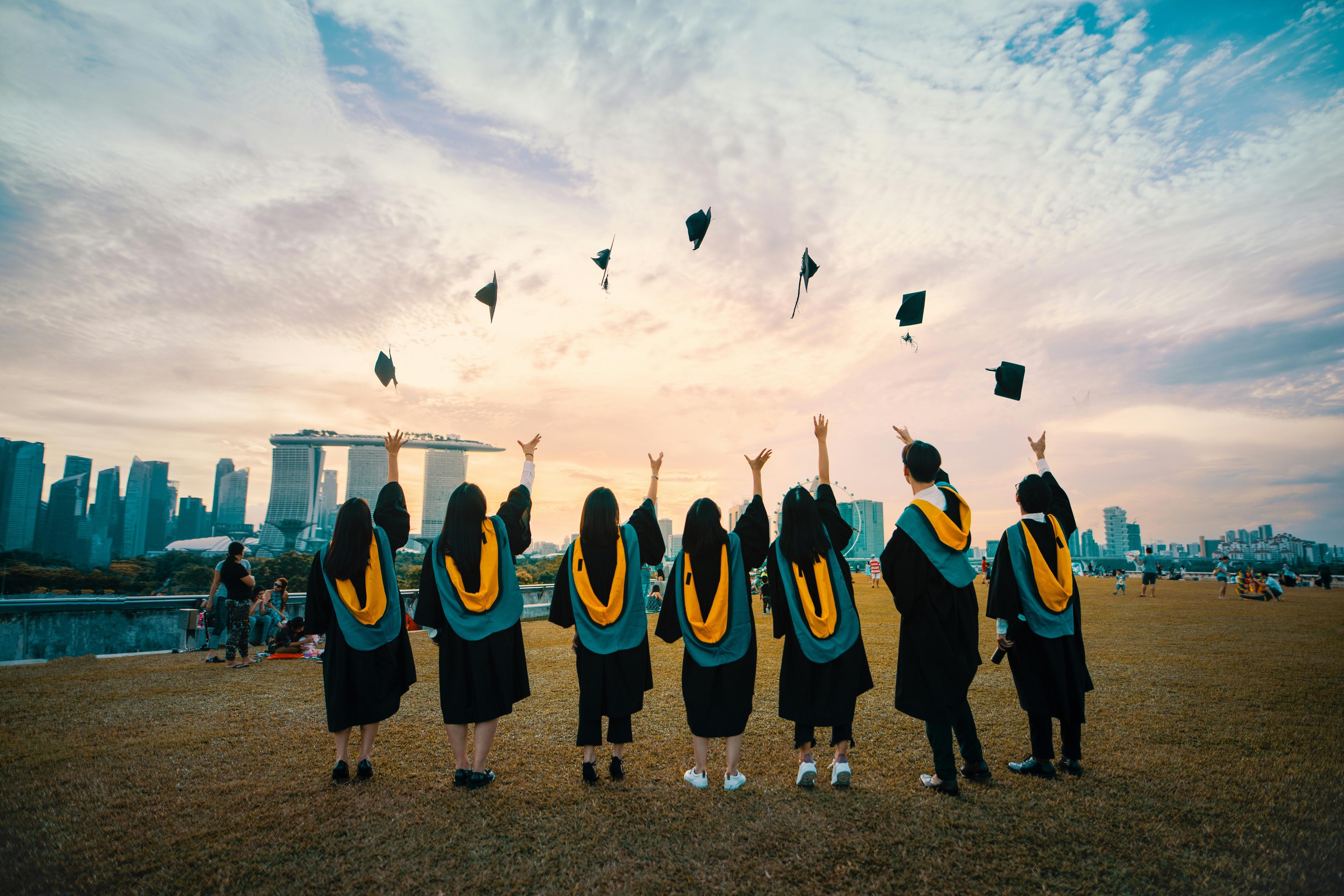 Graduates celebrating in caps and gowns